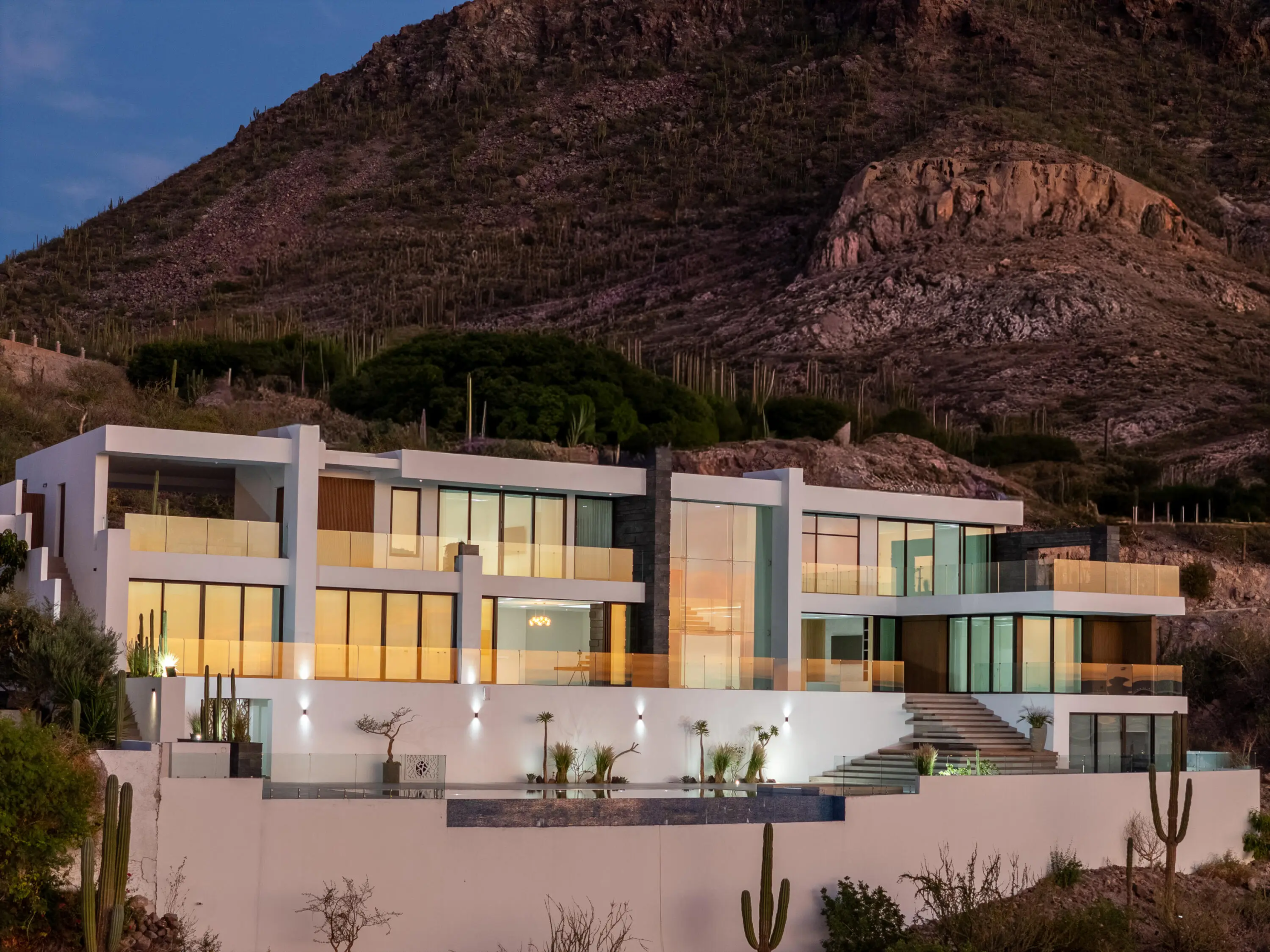 Pedregal Luxury Homes for Sale modern contemporary estate featuring glass walls, open-concept design, and cliffside positioning