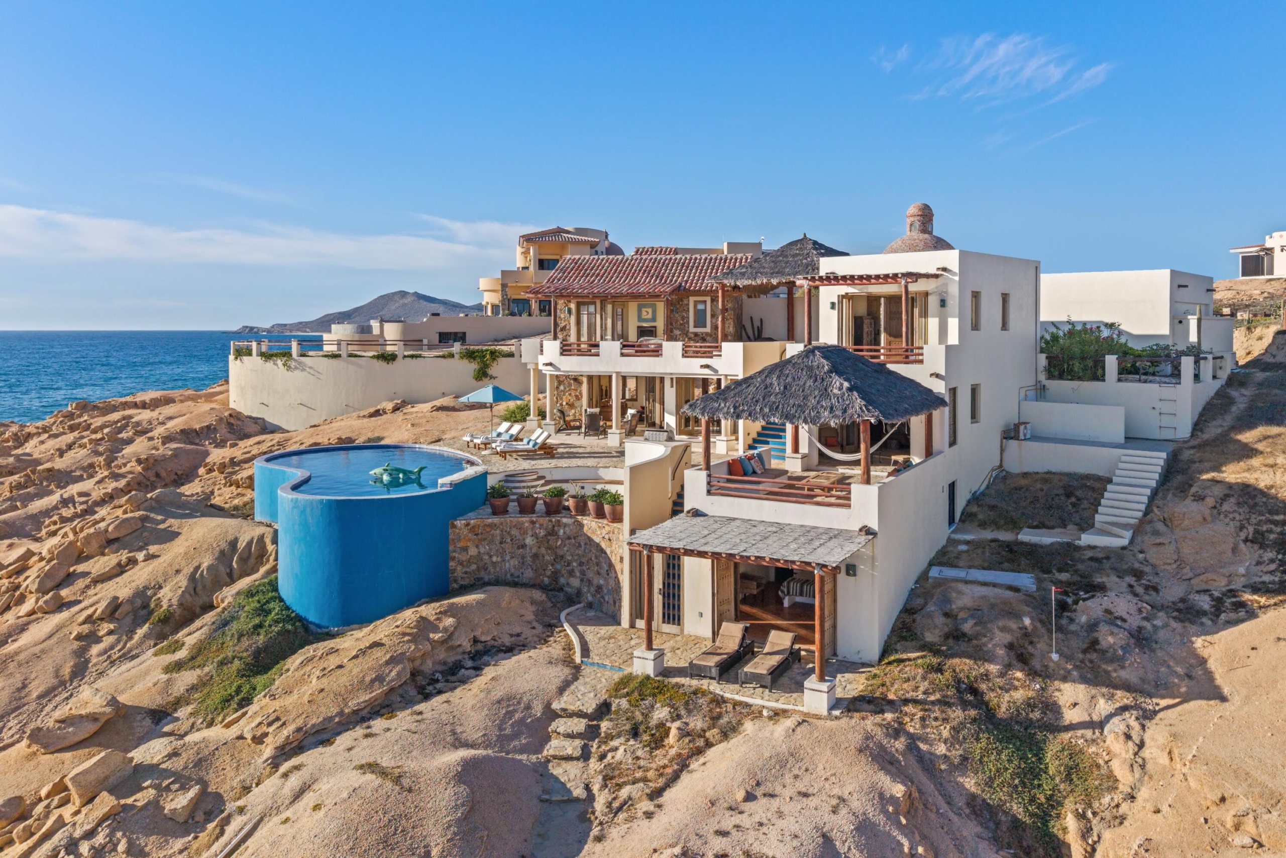 Pedregal Rancholasmargaritas Casa Playa Escondida - Oceanfront Luxury in Baja California SurPerched dramatically on the rocks above the Pacific Ocean, Casa Playa Escondida is a rare oceanfront retreat set along a secluded, pristine stretch of beach. Located within the exclusive off-grid gated community of Rancho Las Margaritas, this one-of-a-kind property offers privacy, tranquility, and breathtaking natural beauty--just a 20-minute drive to the dining and shopping of Cabo San Lucas, 40 minutes from Los Cabos International Airport, and approximately 30 minutes south of Cerritos and Todos Santos.The residence features three spacious ensuite bedrooms, each privately situated yet connected by terraces, pathways, and shared gathering spaces. A dedicated media room offers flexibility as a fourth bedroom or additional guest suite.Expansive terraces and multiple lounging areas provide a variety of vantage points to take in the surrounding landscape, from the rugged coastline to the endless Pacific horizon.The gourmet kitchen is equipped with high-end appliances and designed for both functionality and style. A warm and inviting living and dining area, anchored by a striking fireplace, creates the perfect space for entertaining or relaxing with family and friends. The home is offered fully furnished with includes modern off-grid conveniences such as solar power.Outdoor living is equally exceptional, featuring a swimming pool, firepit, grilling area, and multiple seating spaces--ideal for enjoying the serene coastal setting – 75 Avenue de Marlin, Pacific, BS