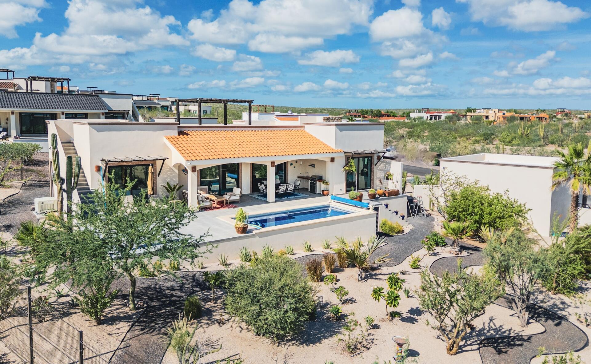 Pedregal Villas Del Centenario Step into Casa Los Sueños in Villas del Centenario, where a bright open-concept kitchen, living, and dining space unfolds across 1,941 ft². Dual sliding glass doors draw you outside to a 580 ft² covered patio with tiled roof, overlooking a heated 10' x 22' pool, outdoor kitchen, and expansive 889.5 ft² terrace--perfect for entertaining. Inside, 10' ceilings, oversized tile, custom alder cabinetry, granite countertops, stainless appliances, and a walk-in pantry elevate everyday living. The primary suite offers dual vanities, a marble shower, and walk-in closet, complemented by two guest bedrooms, full bath, half bath, and laundry room. Welcome to Casa Los Sueños, a recently built residence in the master-planned community of Villas del Centenario, where elevated design meets the relaxed rhythm of Baja living. As you enter, you're greeted by an expansive open-concept kitchen, living, and dining area spanning 1,941 ft² of interior space--designed for both everyday comfort and effortless entertaining. Clean lines, 10' ceilings, and oversized ceramic tile create a sense of openness, while custom alder hardwood cabinetry, granite countertops, stainless steel appliances, and a generous built-in pantry bring both function and style to the heart of the home.Natural light pours in through dual sliding glass doors, drawing you seamlessly outdoors to a 580 ft² covered patio with a tiled roof--your shaded retreat for morning coffee or sunset gatherings. Beyond, a sparkling heated 10' x 22' pool anchors the outdoor living space, complemented by a fully equipped outdoor kitchen and an additional 889.5 ft² of uncovered patio, offering ample room for lounging, entertaining, or simply enjoying the Baja climate – Ave Mision San Diego, San Jose del Cabo, BS