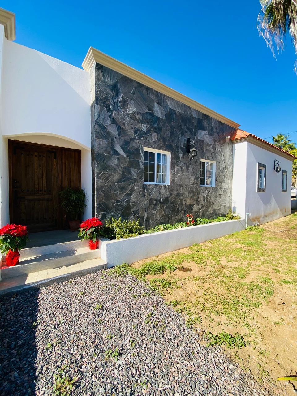 Pedregal Centro-Todos Santos This brand-new, traditional-style home blends modern design with authentic Mexican charm. The residence features an open floor plan with double access to an expansive terrace, along with a spacious primary bedroom and ensuite bath. The kitchen is the heart of the home, where tradition and functionality blend into a warm and inviting space. With a central island, with talavera accesnts, that invites you to cook and share, this kitchen is perfect for those who love the art of cooking. Situated on a corner lot, the property offers dual access points via the main garage and the rear of the home. The grounds are beautifully landscaped with lush, mature greenery.Located in one of the most well-established neighborhoods in Todos Santos, this home is just a 10-minute walk from downtown. – San Vicente, Pacific, BS