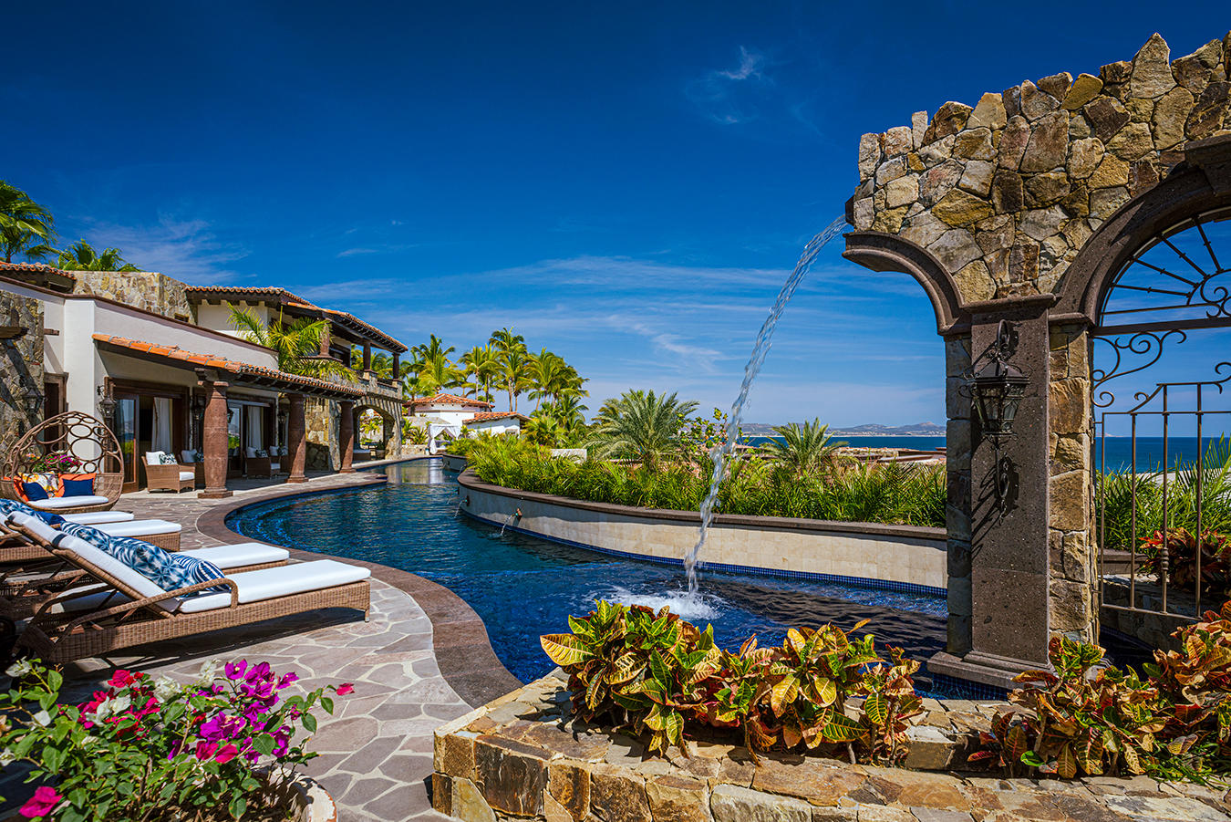 Pedregal Palmilla Cove Villa Encanto, located at Palmilla Cove 5, offers a traditional design with hints of Old Hacienda Architecture, captured in the stone façade and archways throughout. The home offers a calming neutral palette, comfort, and practicality.A bit of wow comes into play with the 100' plus sprawling pool. Flowing the length of the home, the pool features a centrally located sunken spa, wet shelf, spitter fountains and cascading waterfall. Multi outdoor gathering spots are scattered throughout, offering places for lounging or leisurely long lunches, and even sneaking away to a quiet spot.The approach with the interior was to capture the ocean – Villa Encanto, Palmilla Cove 5, San Jose Corridor, San Jose Corridor, BS